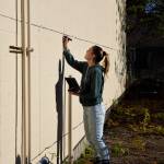Sarah Hughes marks out squares for a new mural in downtown North Bend on Nov. 9. Photos Conor Wilson/Valley Record.