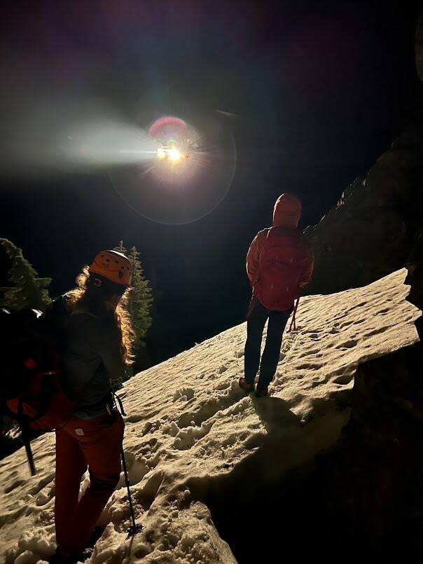 Seattle Mountain Rescue Volunteers Alexis Leader, left, and Carl Johnson, right, rescue a climber from Snoqualmie Pass earlier this month. A Whidbey Island SAR Helicopter hovers above. Photo courtesy of Doug McCall.