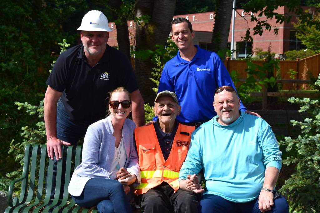 Burt Mann (bottom center) poses for a photo with community members who helped install a sprinkler system at his garden. Top row, from left: Tom Gallagher and Dan Waddell. Bottom Row: Meghan Remington, Mann and Tom Armour. Photo by Conor Wilson/Valley Record.