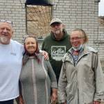 (Photo courtesy of Tom Armour) 
ABOVE: Tom Armour, left, poses for a photo in Ukraine. BELOW RIGHT: Volunteers build panel homes.