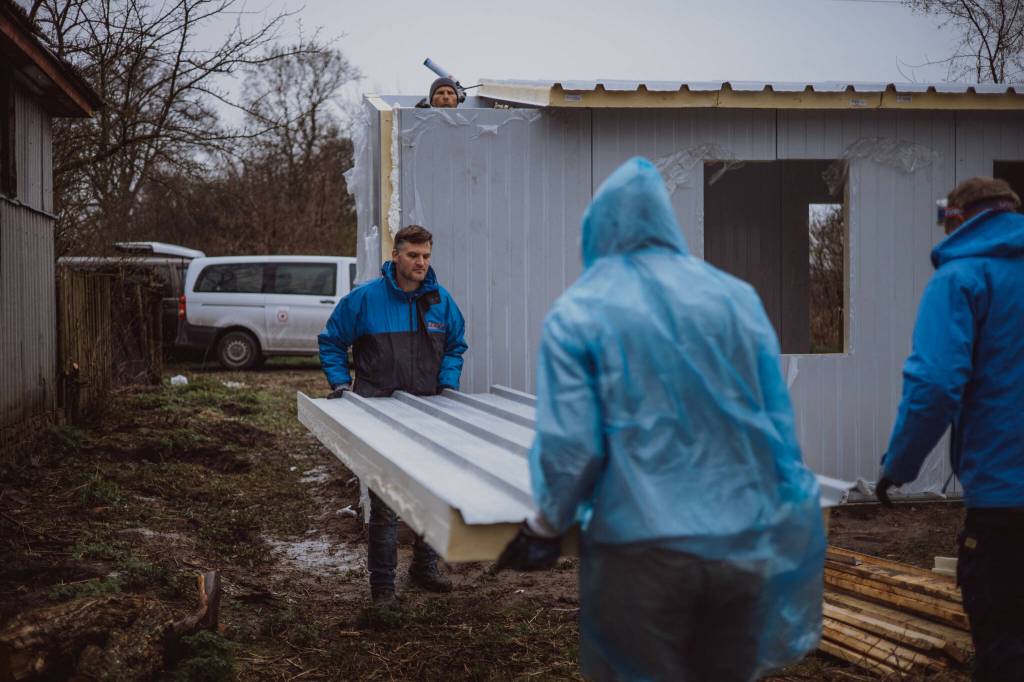 Volunteers build panel homes. (Photo courtesy of Tom Armour)