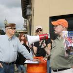 Gardiner Vinnedge, right, and Dave Battey pass a megaphone back and forth as they discuss the history of the buildings in downtown North Bend. 2017 file photo.