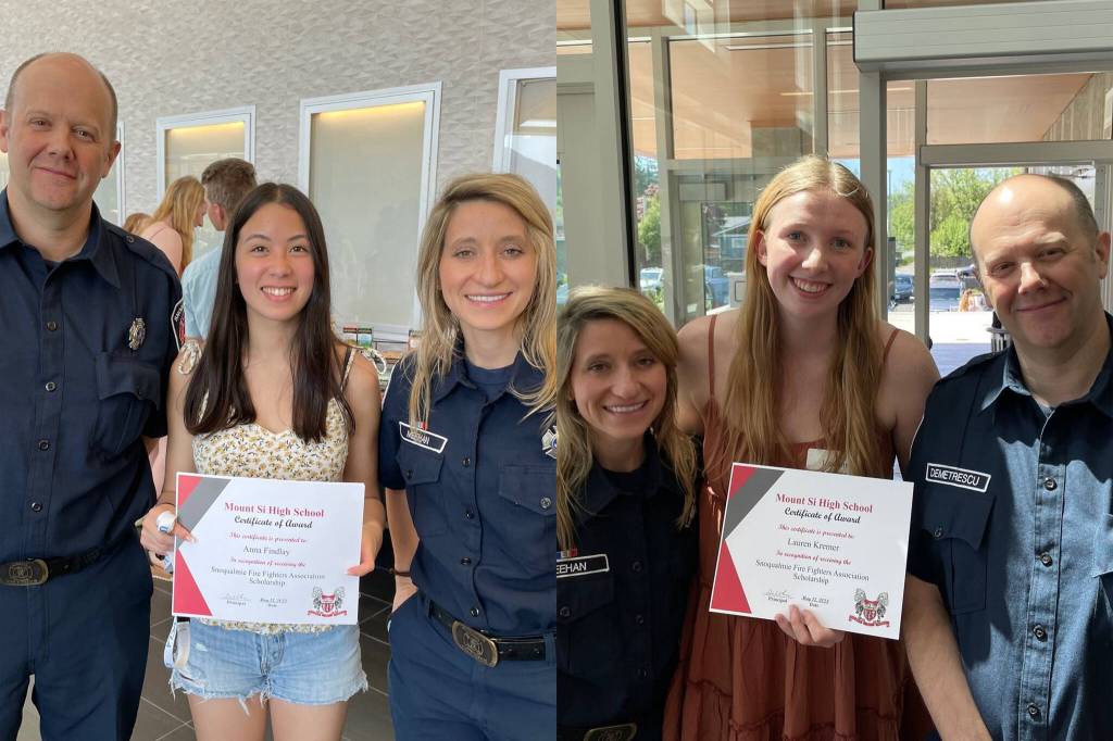 Volunteer Firefighters Josh Demetrescu and Anna Meehan pose for a photo with scholarship award winners Anna Findlay (left) and Lauren Kremer. Photo couresy of the city of Snoqualmie.