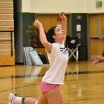 Gianna Valdez keeps a play alive and Savannah Fisher smiles in the background. Ben Ray / The Reporter