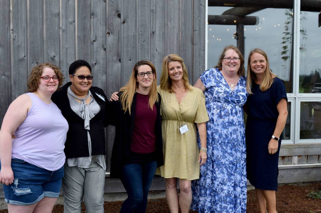 File photo by Conor Wilson/Valley Record
Snoqualmie Valley Shelter Services staff members Kellie Parker (center left) and Jennifer Kirk (center right) pose for a photo alongside Reclaim staff at a 2022 fundraiser. From left: Gabby Burrell, Aisha Gordon, Parker, Kirk, Trissa Dexheimer, Kate Mueller.