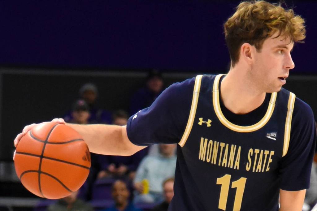 Tyler Patterson is guarded closely by Husky Keion Brooks Jr. (Photo by James Gibowski)
