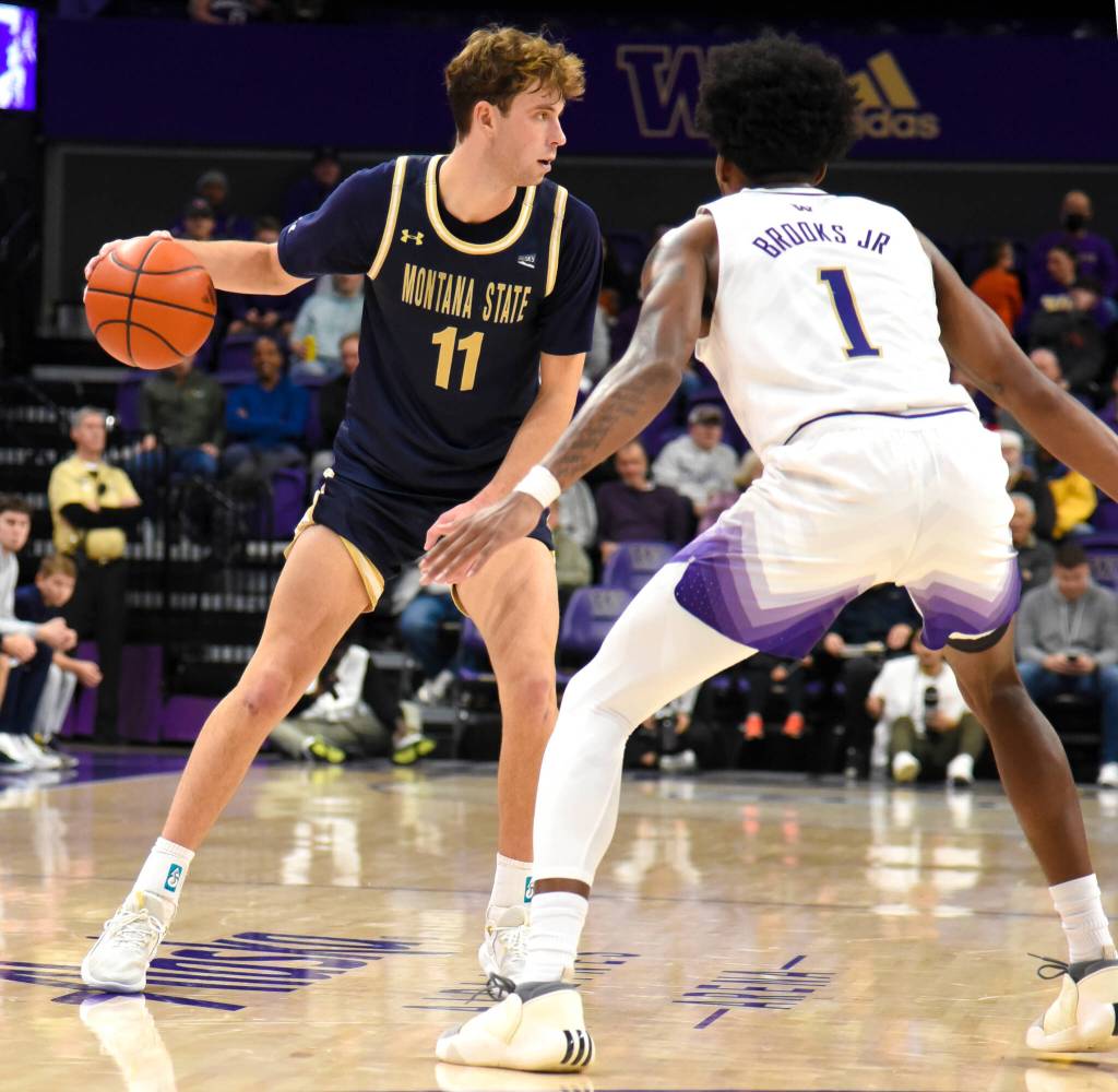 Tyler Patterson is guarded closely by Husky Keion Brooks Jr. (Photo by James Gibowski)