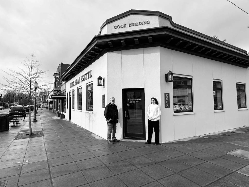Cook and his wife Lisa Cook standing outside the renovated building, which now serves as the Cook Real Estate office. (Photo courtesy of David Cook)