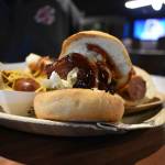 A plate of food, showcased with a porkbelly sandwich. Ben Ray / The Reporter