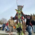 Artist Dan Cautrell poses with his wood-carved praying mantis at Depot Park on Saturday, March 30. Cautrell creates a new piece of art for each March of the Vegetables. Photos by Grace Gorenflo/For the Valley Record