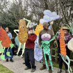 A group of volunteers line up as the March of the Vegetables at Depot Park on Saturday, March 30. Artist Paula Strobel made the vegetable figures with cardboard and paint. Photos by Grace Gorenflo/For the Valley Record