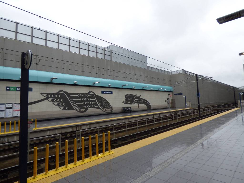 A metal-cut mural depicting a Dragon and Phoenix lines the Spring District Station, situated between the Wilburton and RedBell stations. This mural, created by Chinese-indigenous artist Louie Gong, is a mixture of Coast Salish and Chinese paper-cutting designs. According to Gong, this art represents the experience of mixed-race people. (Cameron Sires/Sound Publishing)