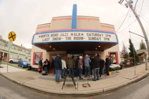 The thirteenth annual North Bend Jazz Walk was held April 27. Nineteen venues throughout downtown North Bend hosted 28 jazz bands with at least 100 total musicians from 5 p.m. to midnight. Learn more at northbendjazzwalk.com. Pictured: Excited guests hide from the rain under the cover of the North Bend Theatre. Photos by Ben Magnus/For the Valley Record