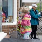 Little kid standing at the window of North Bend Bakery, trying to imitate the Jake Bergevin Trio inside.
