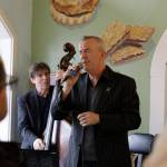 Jake Bergevin singing a lovely song to viewers sitting inside of the North Bend Bakery, keeping their minds off of the sweets behind him.