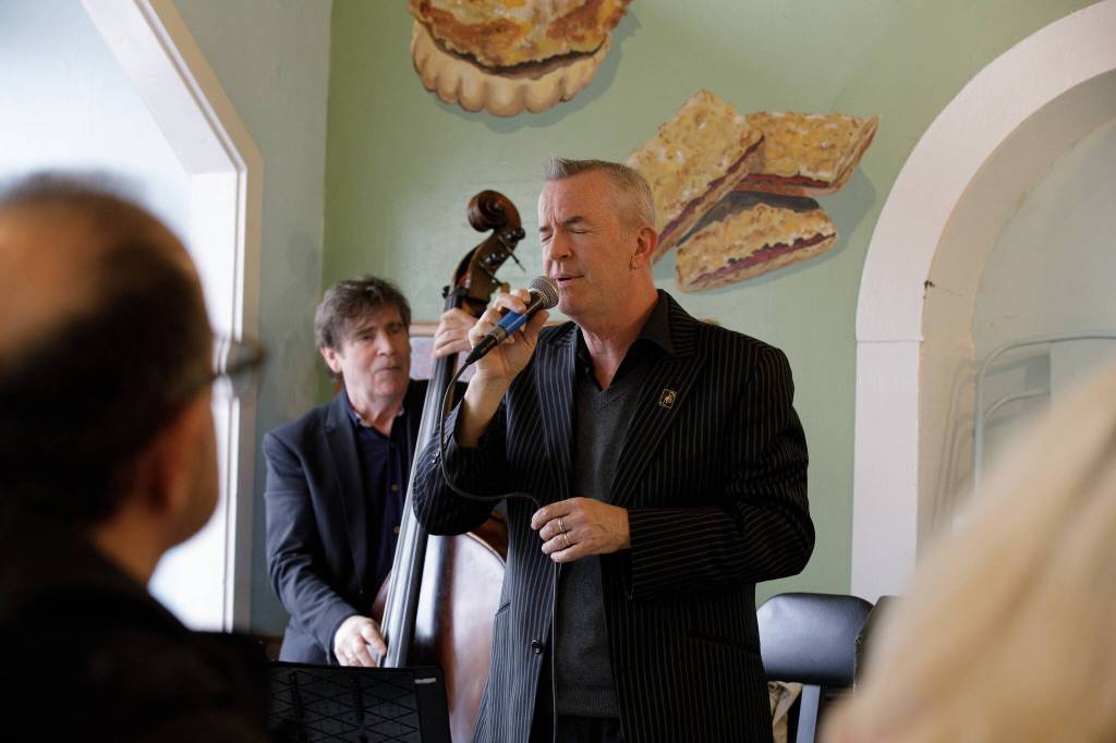 Jake Bergevin singing a lovely song to viewers sitting inside of the North Bend Bakery, keeping their minds off of the sweets behind him.