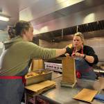 Chef Kristen Schumacher and Olivia Longstaff, education and engagement coordinator, bag and weigh portions of truffle potato chips in the Carnation Farms kitchen on March 28. Photos by Grace Gorenflo/For the Valley Record