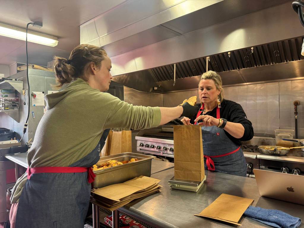 Chef Kristen Schumacher and Olivia Longstaff, education and engagement coordinator, bag and weigh portions of truffle potato chips in the Carnation Farms kitchen on March 28. Photos by Grace Gorenflo/For the Valley Record