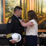 Dep. Chief Chris Browns wife pinning on his new badge. (Photo courtesy of the city of Snoqualmie)