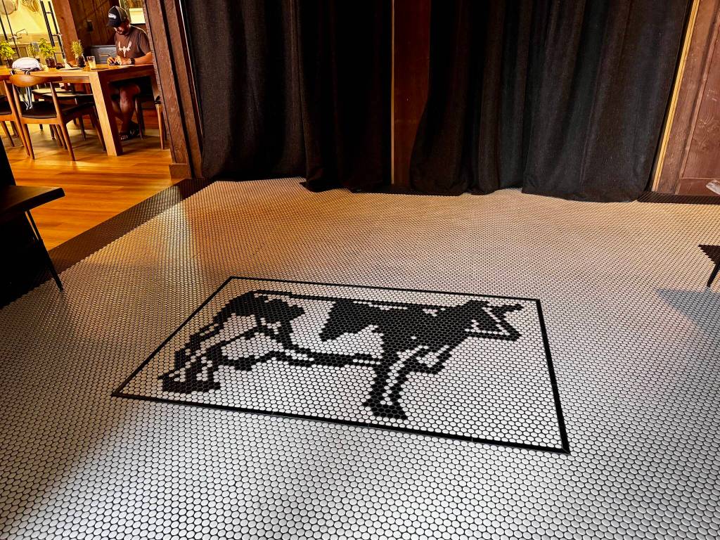 A tile motif of the Carnation Farms cow statue greets guests in the foyer of the Farmview Kitchen Aug. 14, 2024. Photos by Grace Gorenflo/For the Valley Record