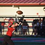 Mount Si Wide Receiver extends his arms to make an impressive catch at the Charlie Kinnune Scarlet and Gray Game.