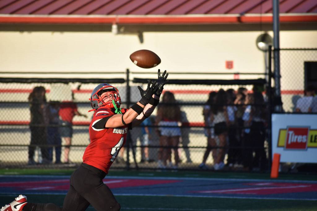Mount Si Wide Receiver extends his arms to make an impressive catch at the Charlie Kinnune Scarlet and Gray Game.
