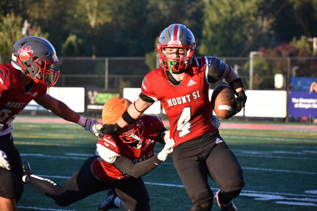 Mount Si ball carrier breaks a tackle at the Charlie Kinnune Scarlet and Gray Game. Photos by Ben Ray / The Record