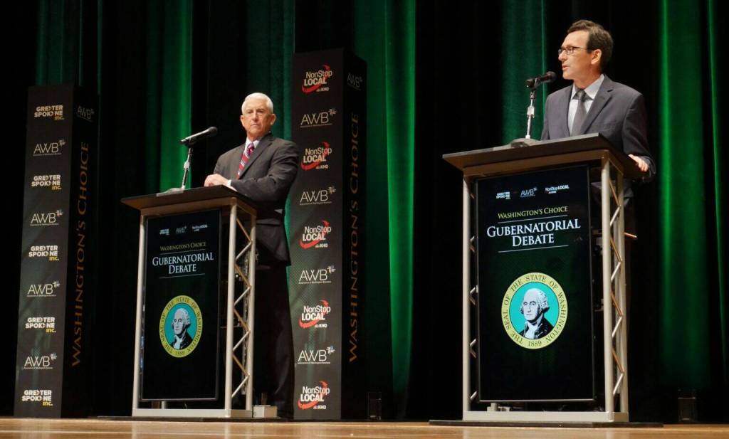 Former Congressman Dave Reichert, a Republican, left, and Washington state Attorney General Bob Ferguson, a Democrat, right, are seen on stage during the second debate of the 2024 Washington state governors race, Sept. 18, 2024, in Spokane, Wash. (Bill Lucia/Washington State Standard)