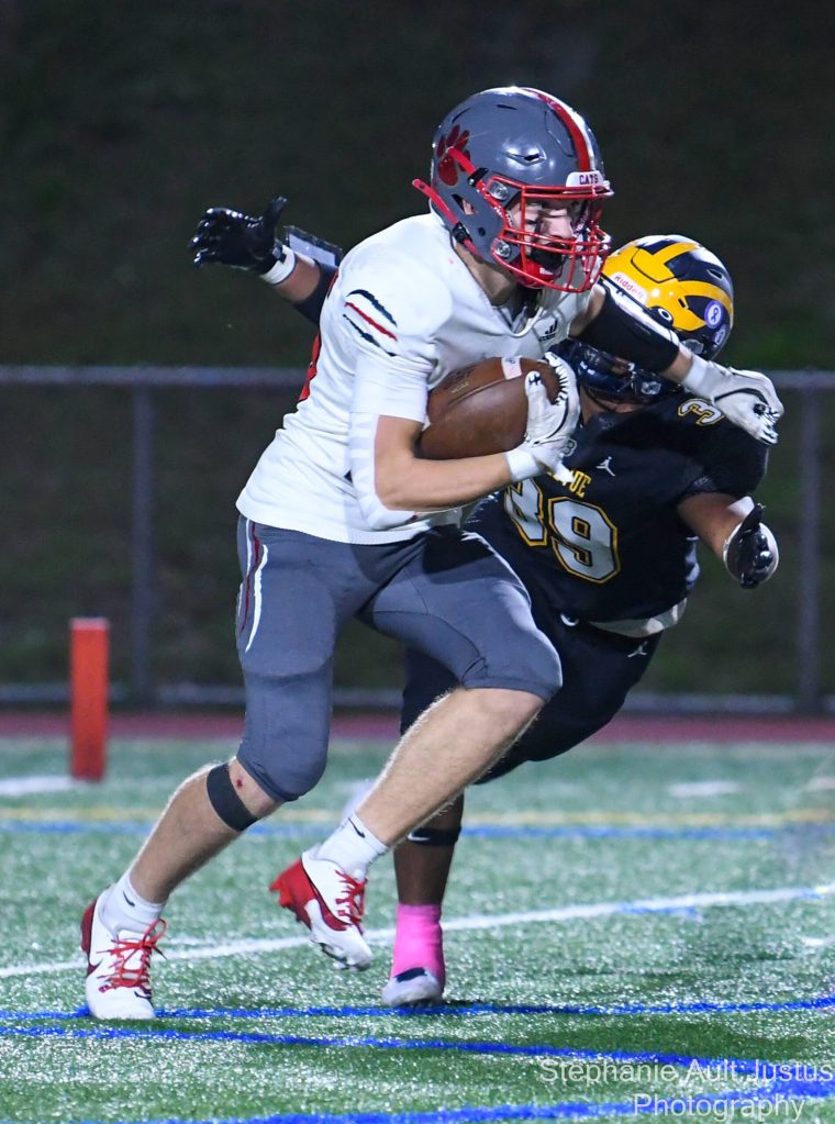Mount Si High junior Max Castagnola runs the ball while Bellevue Highs sophomore Brogan Gallager tackles him. Photo courtesy of Stephanie Ault Justus