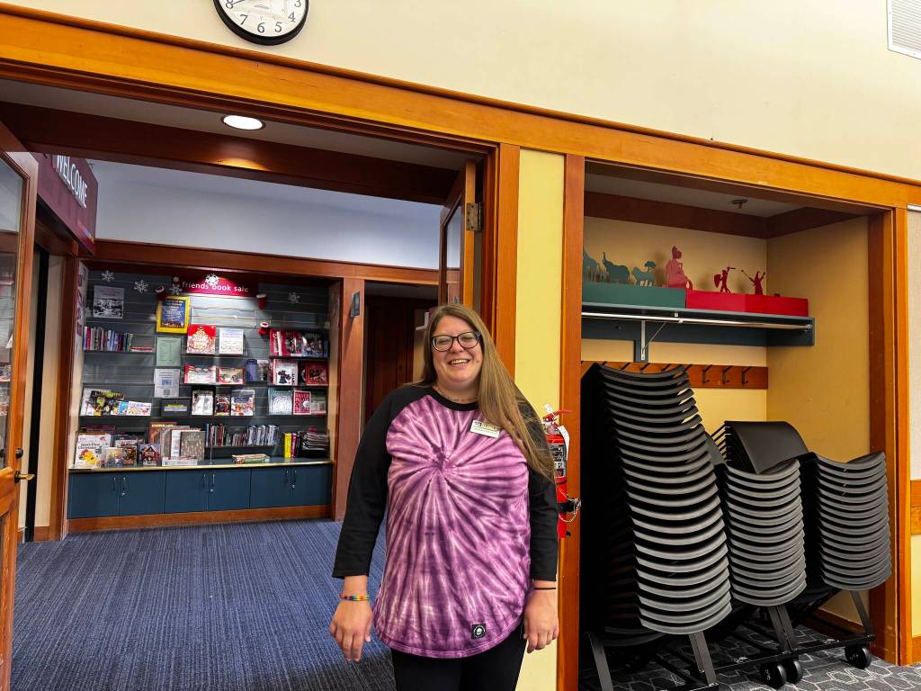 North Bend librarian Lindsay Ellsworth stands for a photo in the room where the Lambert House youth group meets monthly. Ellsworth has been a facilitator of the group since its beginning. Photo by Grace Gorenflo/Valley Record