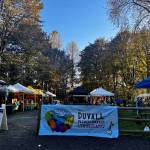 A banner with this seasons new branding hangs at the entrance to the Duvall Farmers Market on Oct. 3, 2024. (Grace Gorenflo/Valley Record)