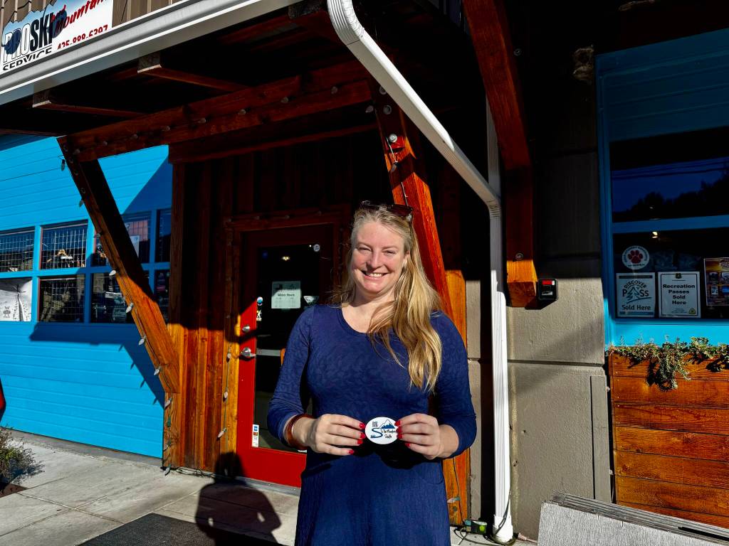 To the Mountain shuttle company owner Meg White stands for a photo outside Pro Ski Service, a partner business and one of the shuttles stops in North Bend. (Grace Gorenflo/Valley Record)