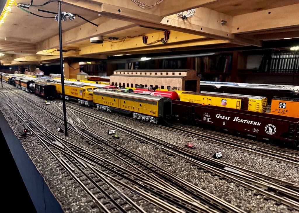 Stationary trains sit on the tracks of the Pacific West Rail display, including models of trains from Great Northern, Union Pacific and Southern Pacific rail companies. (Grace Gorenflo/Valley Record)