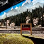 A miniature replica of the Welcome to Skykomish sign sits with a backdrop of handmade trees and painted clouds. (Grace Gorenflo/Valley Record)