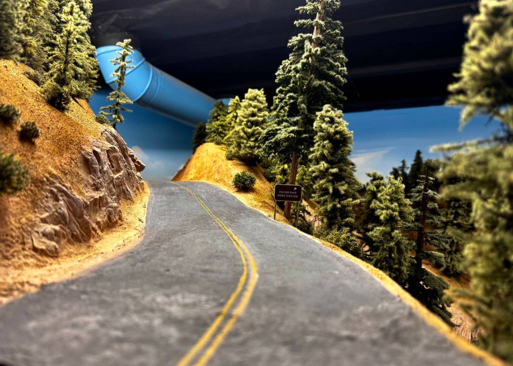 A Feather River scenic overlook sign sits on an artificial road. The Feather River Route takes trains through the Sierra Nevada. (Grace Gorenflo/Valley Record)
