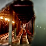 Miniature figures are seen working on a railroad in a tunnel. The scene is set up in a hole in the wall. (Grace Gorenflo/Valley Record)