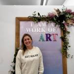 Anne Williams, owner of the Snoqualmie Art Major Studios location, stands in her studios photo station at her grand opening Dec. 5, 2024. (Grace Gorenflo/Valley Record)