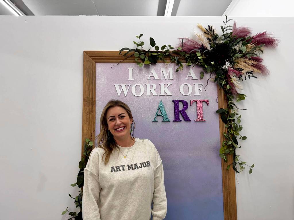 Anne Williams, owner of the Snoqualmie Art Major Studios location, stands in her studios photo station at her grand opening Dec. 5, 2024. (Grace Gorenflo/Valley Record)