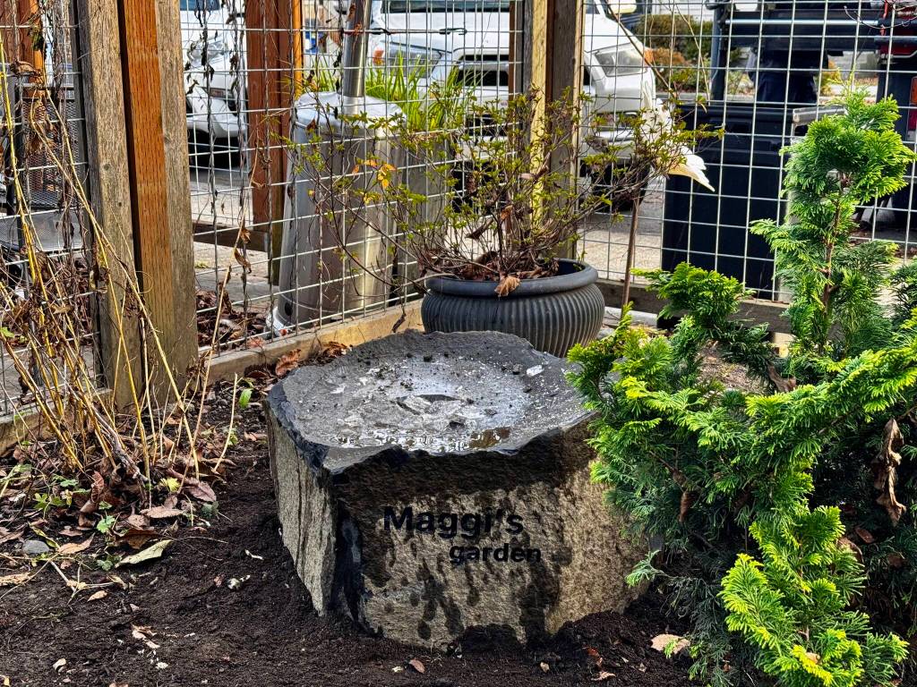 Down to Earths new bird bath, in honor of the shops late owner Maggi Whitaker, is engraved with Maggis Garden.