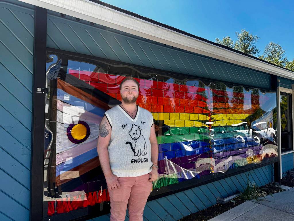 Axton Burton stands with their Intersex-Inclusive Progress Pride flag ribbon art in downtown Duvall on June 9, 2024. (File photo)