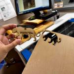 Romalyn Hatol, a junior at Mount Si High School, shows the finished product after laser-cutting a wood cougar ornament. (Grace Gorenflo/Valley Record)