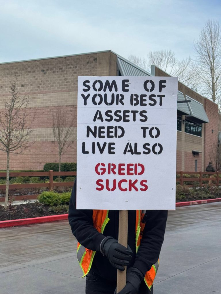 A Costco truck driver holds up a homemade sign at the Teamsters rally, Jan. 23, 2025. (Grace Gorenflo/Valley Record)