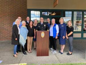 Police Chief Brian Lynch with Snoqualmie and North Bend officials at the June 24 opening of a police substation at North Bend Outlet Mall. (Valley Record file photo)