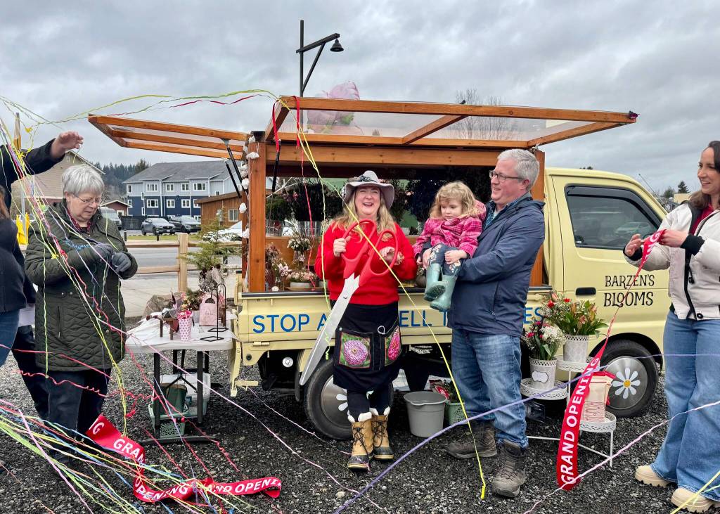 Streamers fly after owner of Barzens Blooms Erin Barzen cuts the ribbon with her family, Feb. 14, 2025. From left: Barzens mother, Nancy Barzen; Erin Barzen; Barzens daughter, Lucie; Barzens husband, Cory Dochow; Carnation Mayor Adair Hawkins. Grace Gorenflo/Valley Record