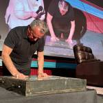 Actor Ray Wise, who played Leland Palmer in Twin Peaks, imprints his hands in a block of wet concrete at the North Bend Theatre, Feb. 22, 2025. The concrete block will be added to the sidewalk outside the theater. (Grace Gorenflo/Valley Record)