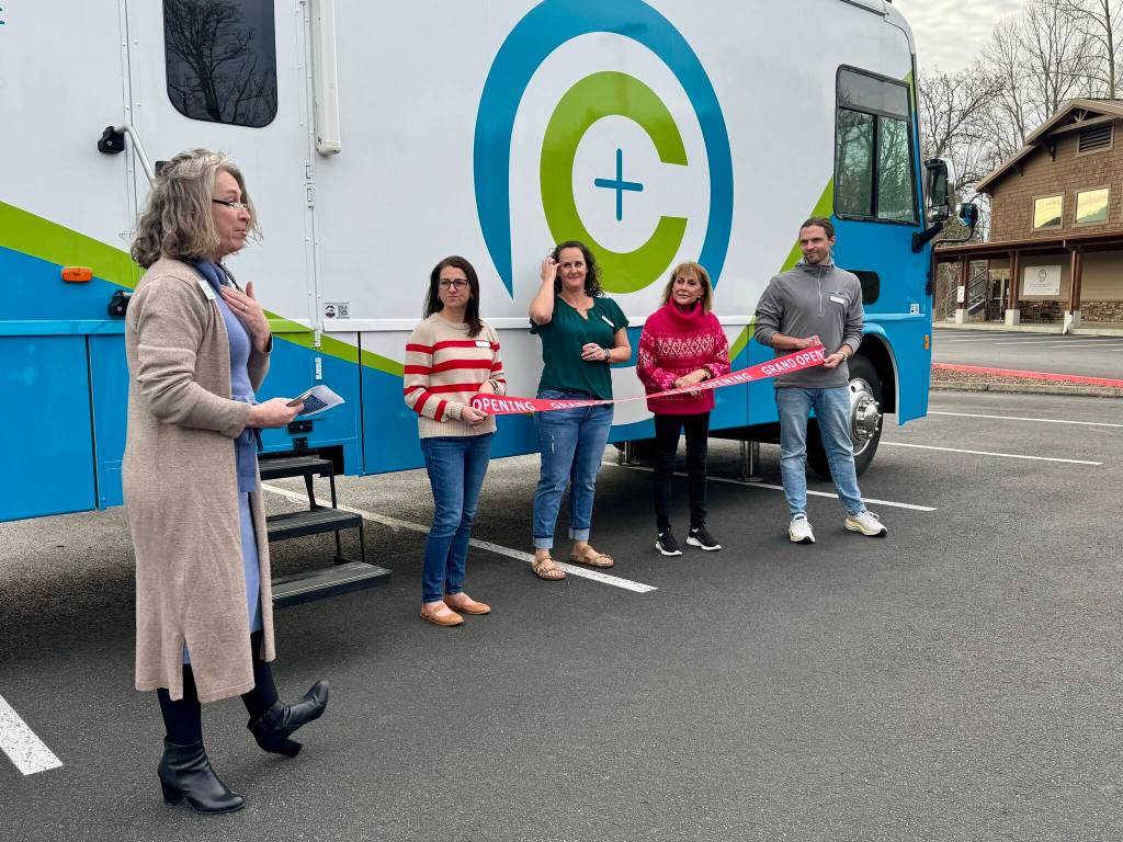 Helene Wentink, communication and development director for Empower Youth Network, speaks to the crowd at CarePoints ribbon cutting, Feb. 26, 2025. From left: Wentink; Andrea Pitman, CarePoint clinic manager; Misty Messer, CarePoint executive director; Darcy Dinwiddie, Carnation Chamber of Commerce director; Todd Wright, CarePoint medical director. Grace Gorenflo/Valley Record