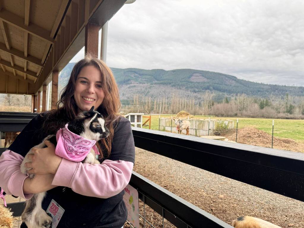 Owner of Feral Woman Farm Lulu Redder holds a baby goat named Cowboy at her petting zoo, March 8, 2025. (Grace Gorenflo/Valley Record)