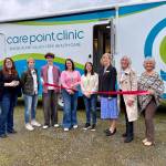 CarePoint Clinic Executive Director Misty Messer cuts the ribbon at the clinics second ribbon-cutting ceremony, March 12, 2025. (Grace Gorenflo/Valley Record)