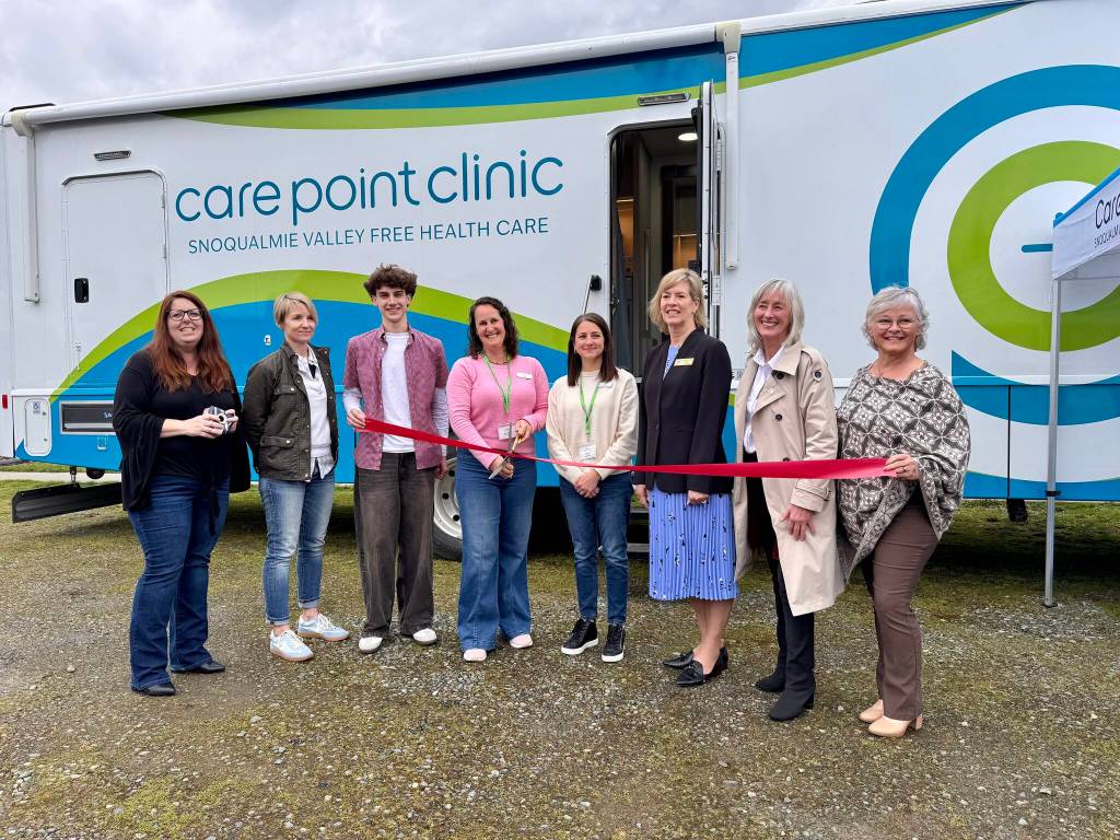CarePoint Clinic Executive Director Misty Messer cuts the ribbon at the clinics second ribbon-cutting ceremony, March 12, 2025. (Grace Gorenflo/Valley Record)