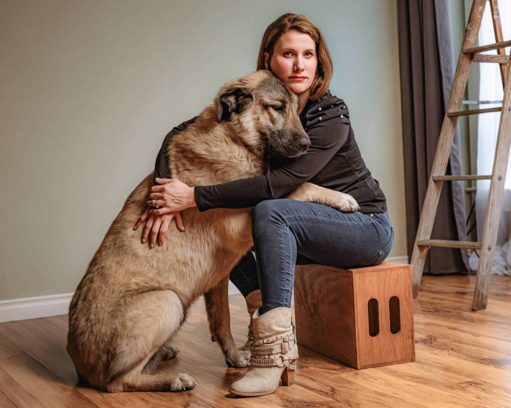 Beyond the Stables owner Christina Lathrop poses for a portrait with her dog. Photo courtesy of Christina Lathrop/Beyond the Stables photography